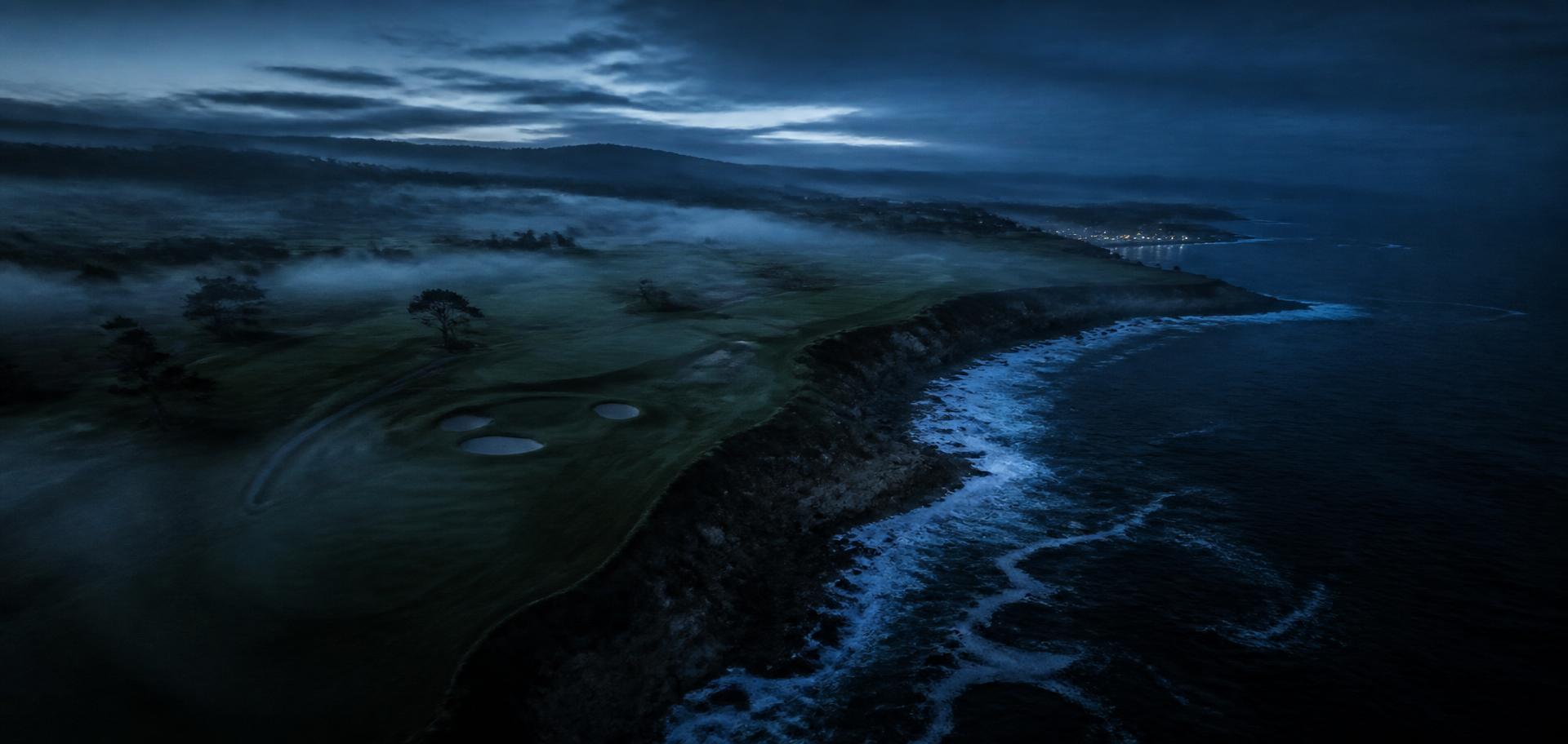 Aerial view of a coastal golf course at blue hour