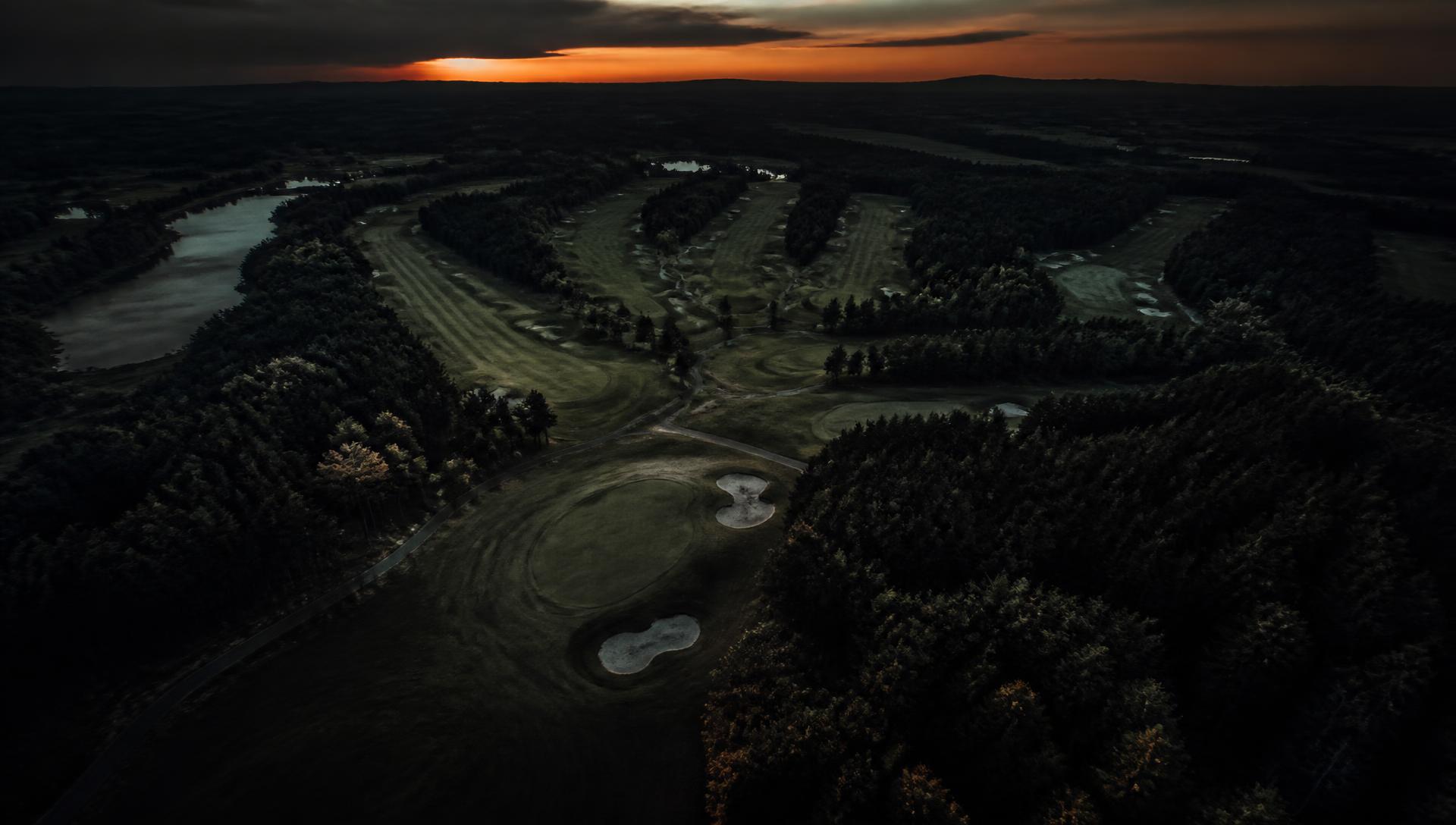 Aerial view of a golf course at dusk